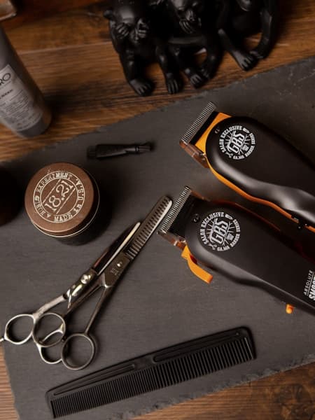 Hot towel shave in progress with steaming cloth draped over the client's face
