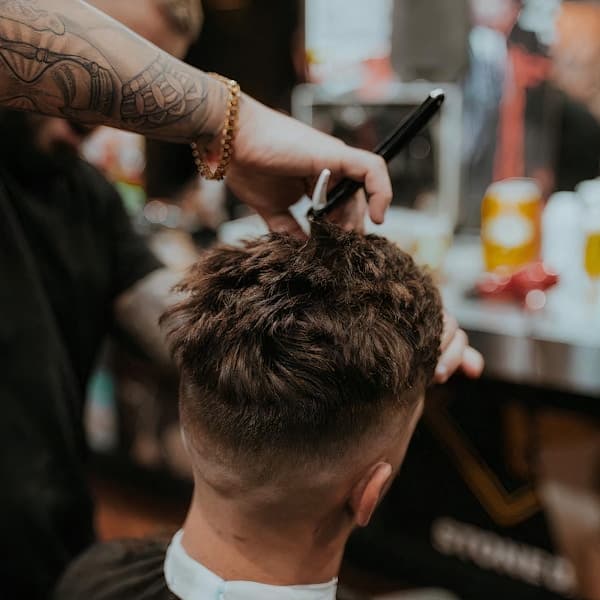 Close-up of a barber carefully trimming and shaping a beard