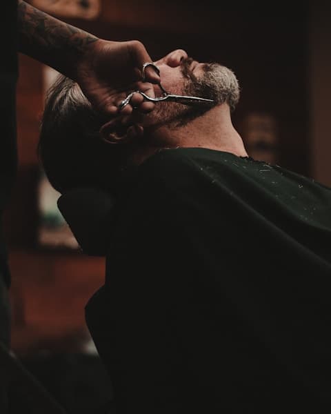 Barber tools neatly arranged — scissors, combs, and clippers on a leather mat