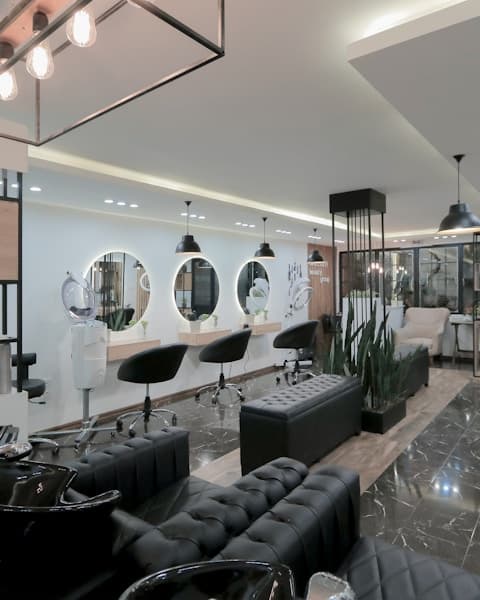 Detail of a restored vintage barber chair with chrome and red leather