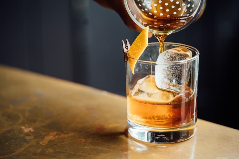 The cocktail bar at Restaurant Demo bathed in moody amber lighting