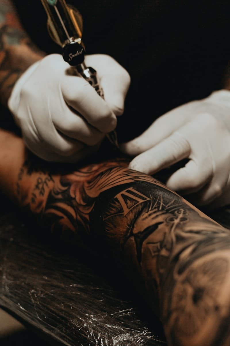 Blackwork geometric tattoo with precise linework and symmetrical patterns