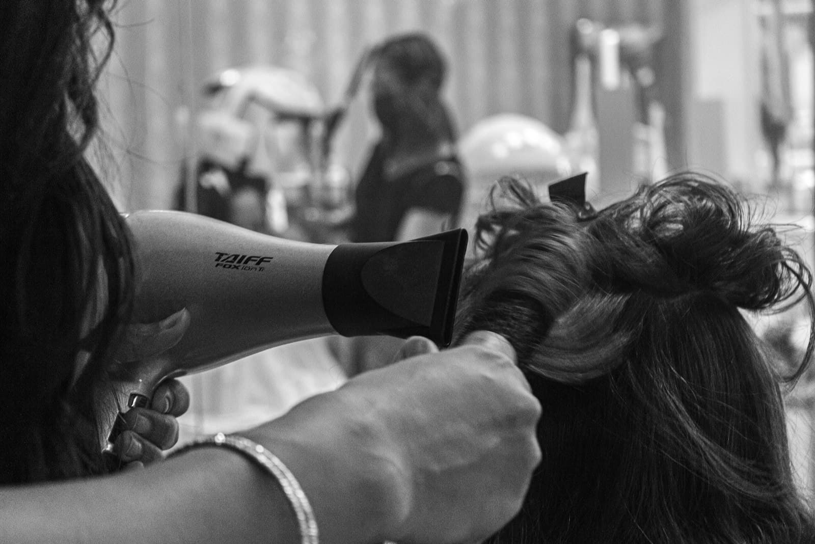 Dark moody tattoo studio interior with professional equipment and atmospheric lighting